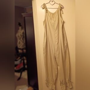 Cream Sleeveless Jumpsuit with Pockets.